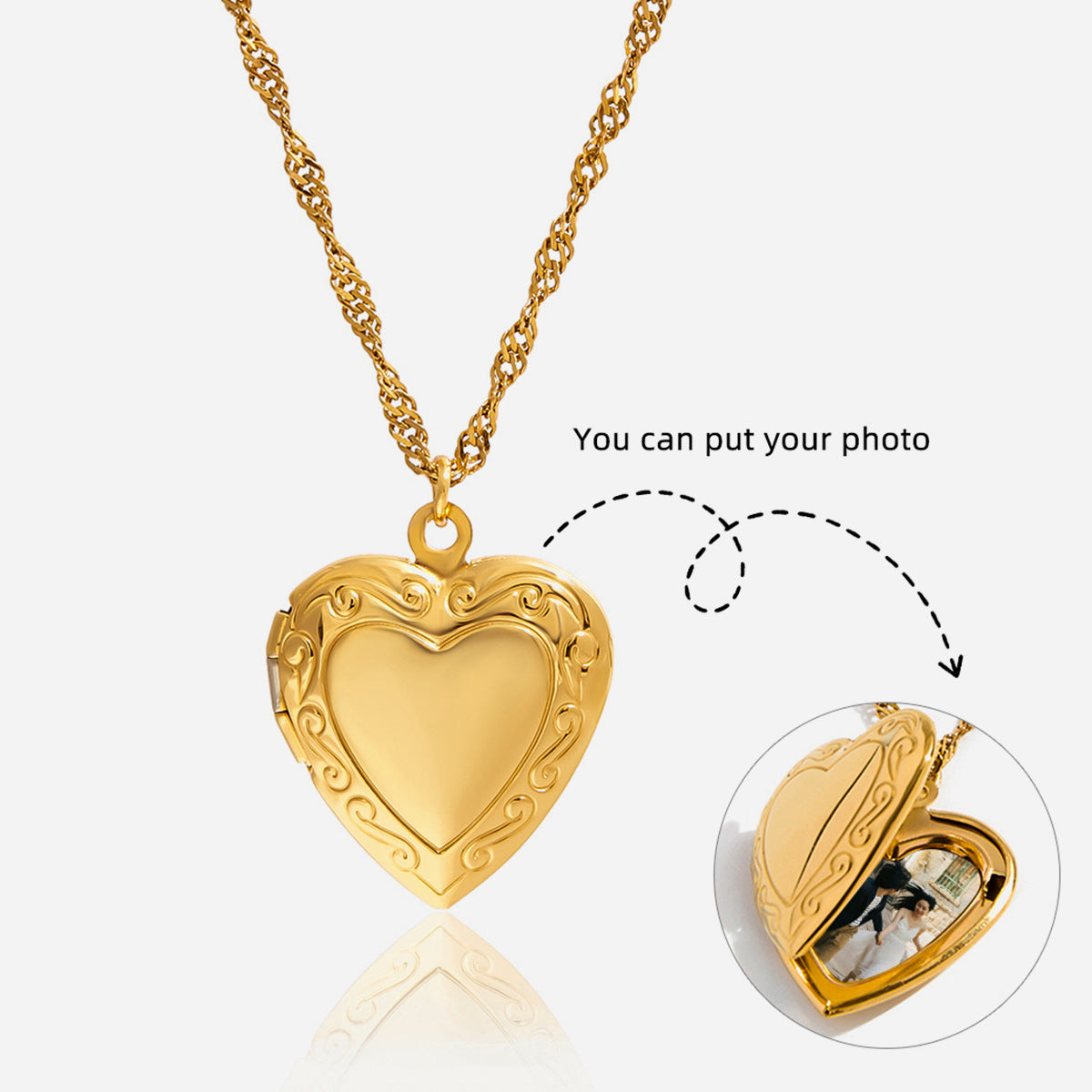 Gold heart-shaped locket with chain on a white background