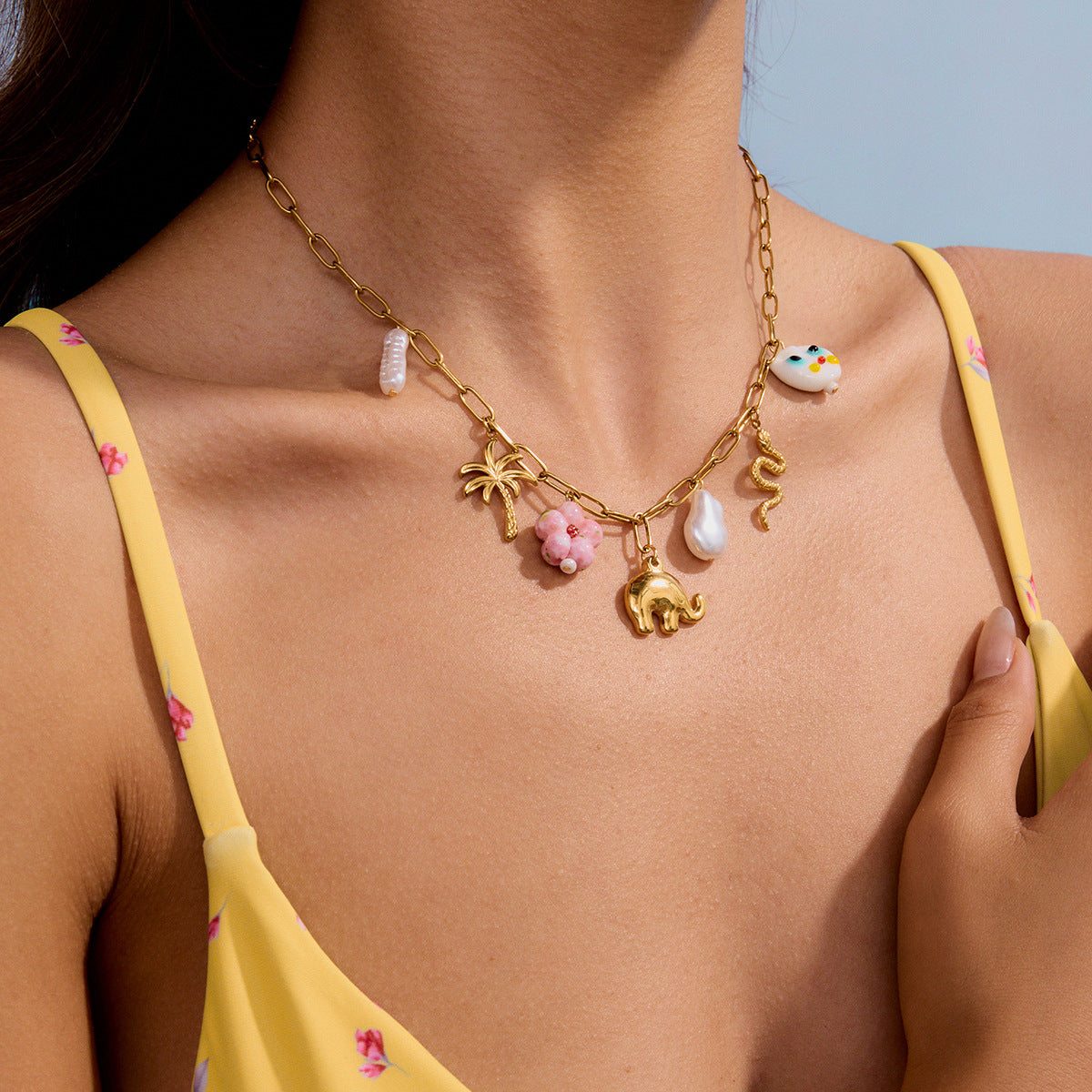 Summer beach necklace with gold snake, palm tree and playful ceramic charm