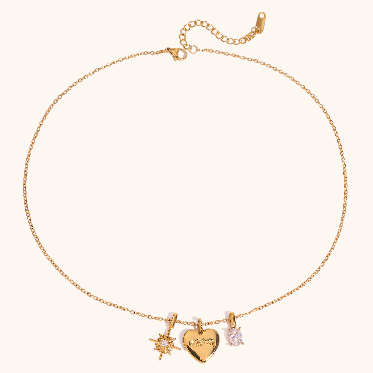 Close-up of gold mom heart charm necklace with starburst and CZ stone