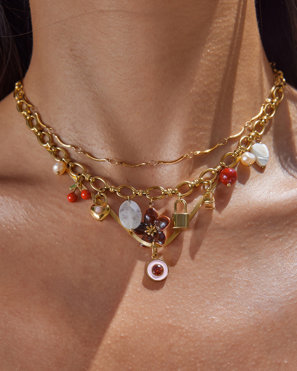Gold necklace with various charms on a person's neck