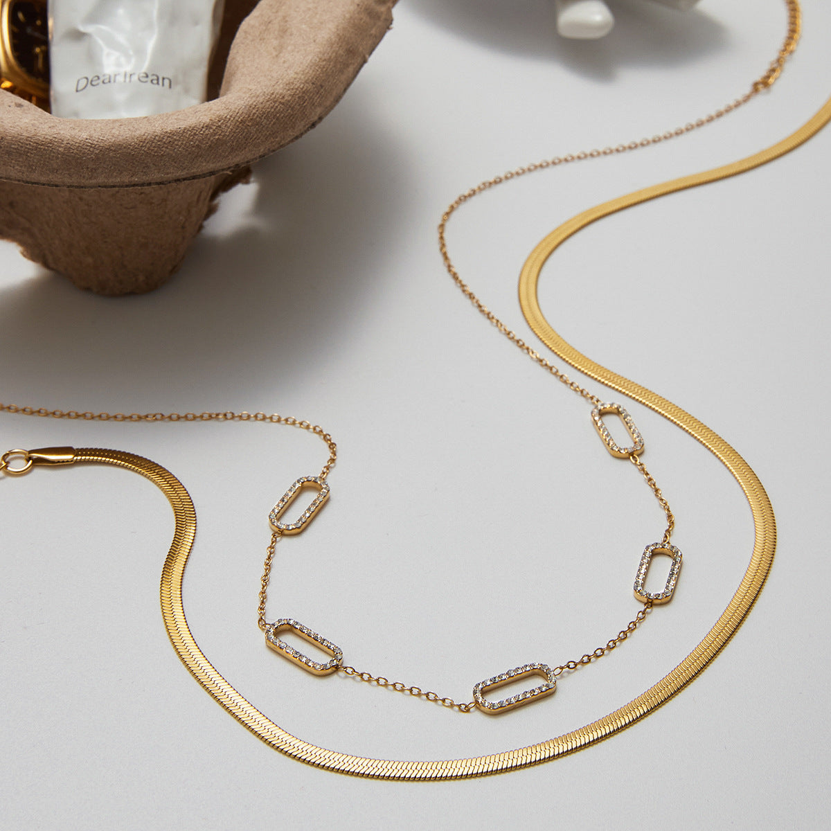 Close-up of a chic gold choker with sparkling pave crystal open links.