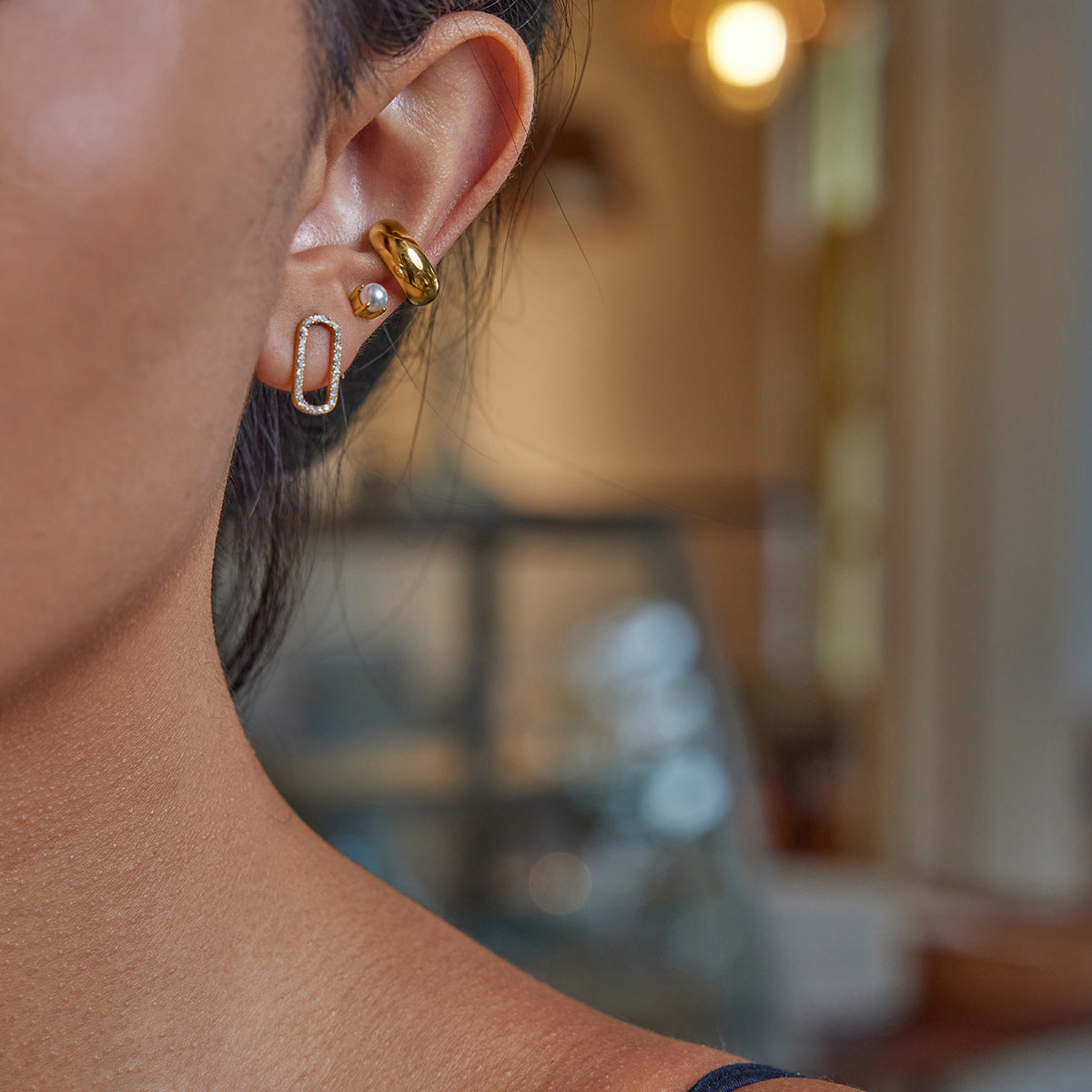 Model wearing pearl-backed rhinestone oval stud earrings