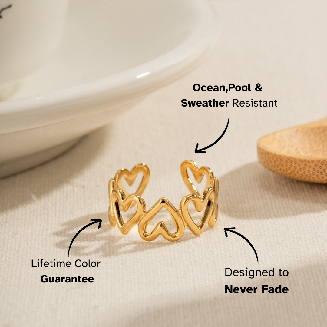 Sparkly wavy gold ring shown on sand background.