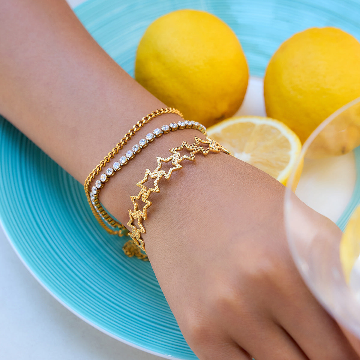 Woman wearing star open cuff bracelet with lemon background