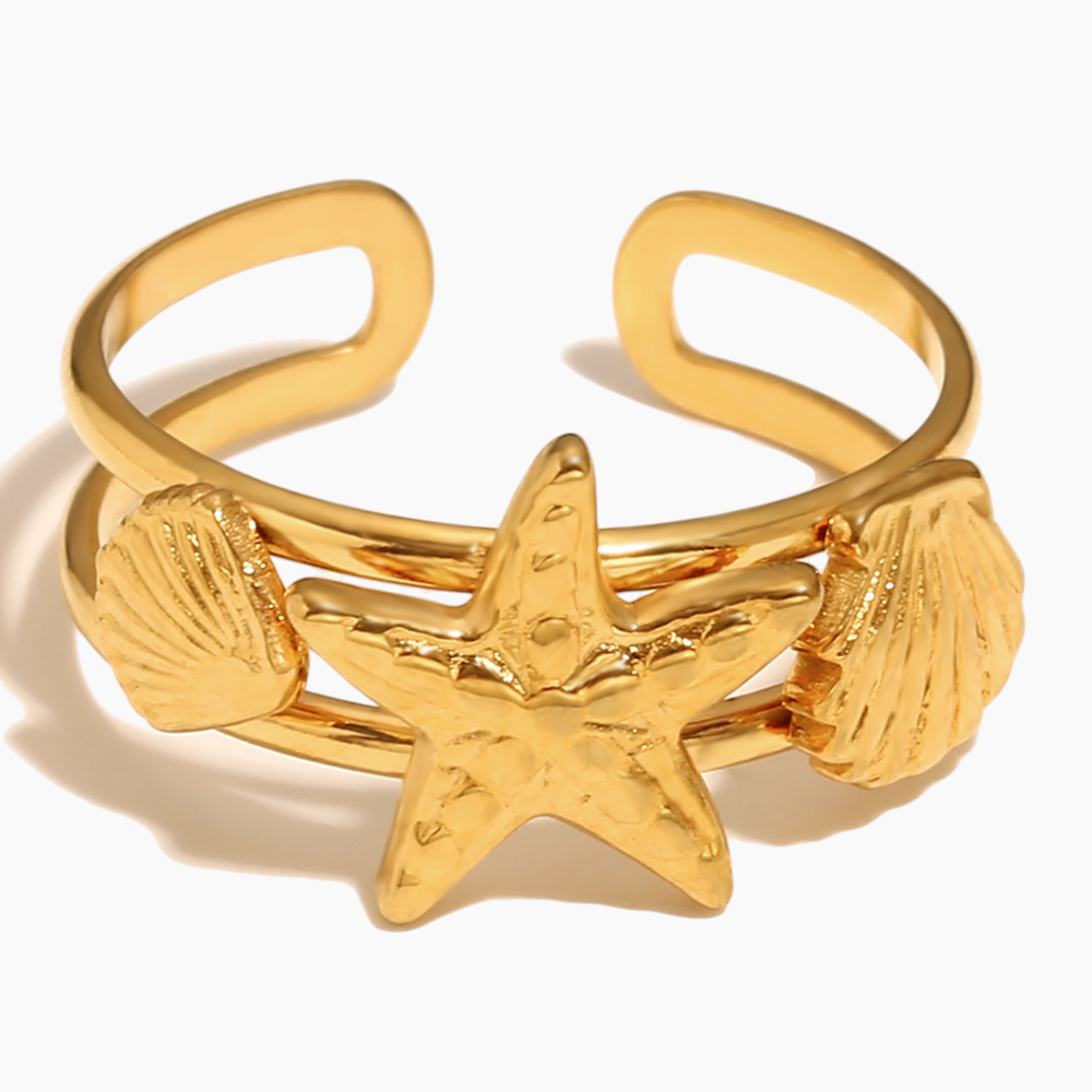 Adjustable gold starfish ring shining in natural sunlight