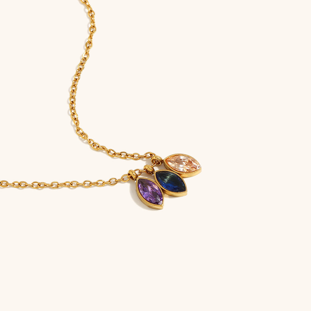 Side angle of gemstone pendant necklace with luxe sparkle details