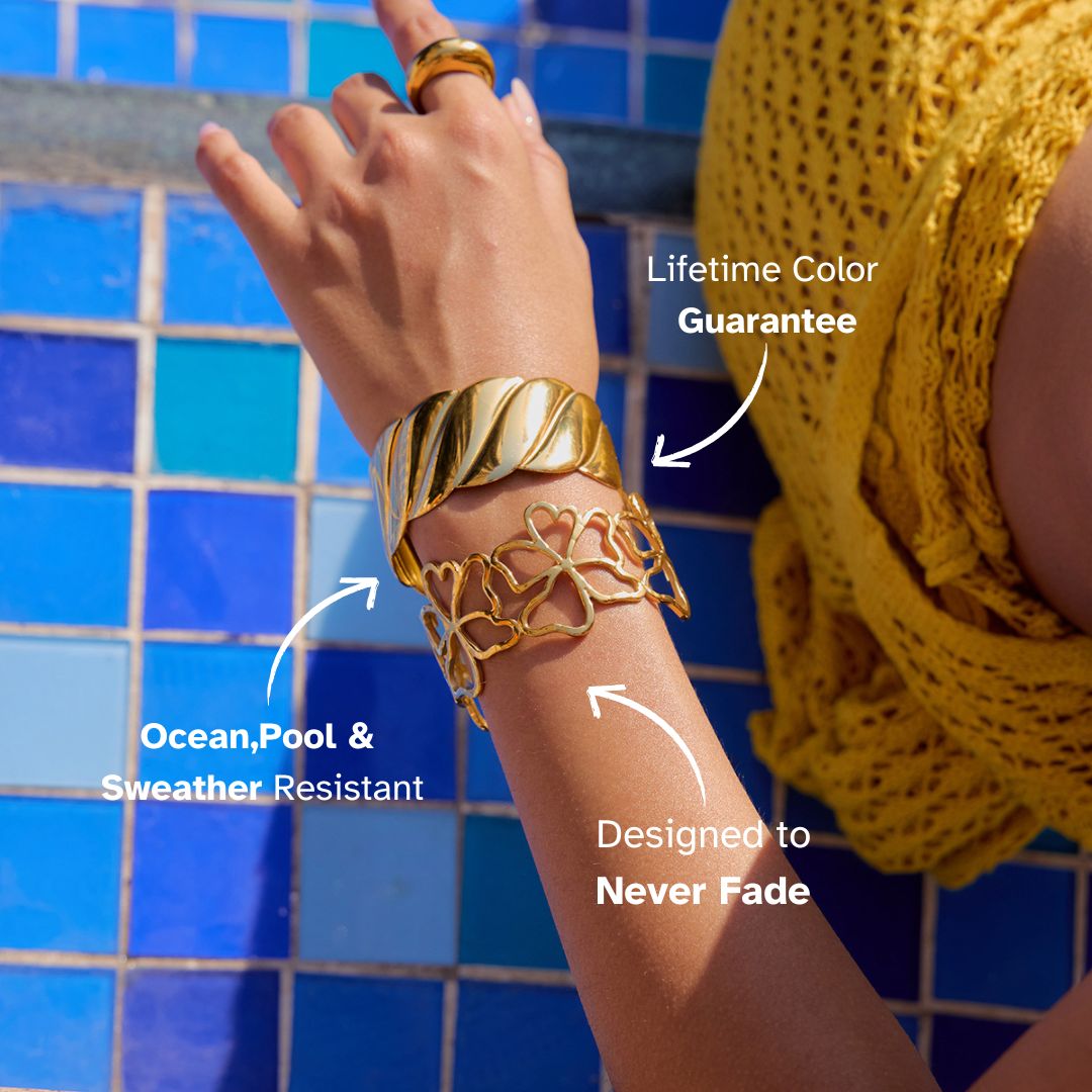 Close-up of polished gold cuff bracelet with elegant twisted texture, styled for summer resort outfit.