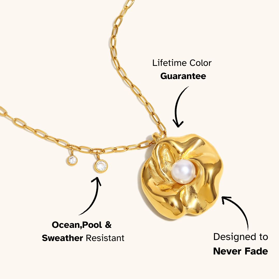 Gold flower necklace with pearl center and zircon charms on cream background, perfect for elegant summer outfits.