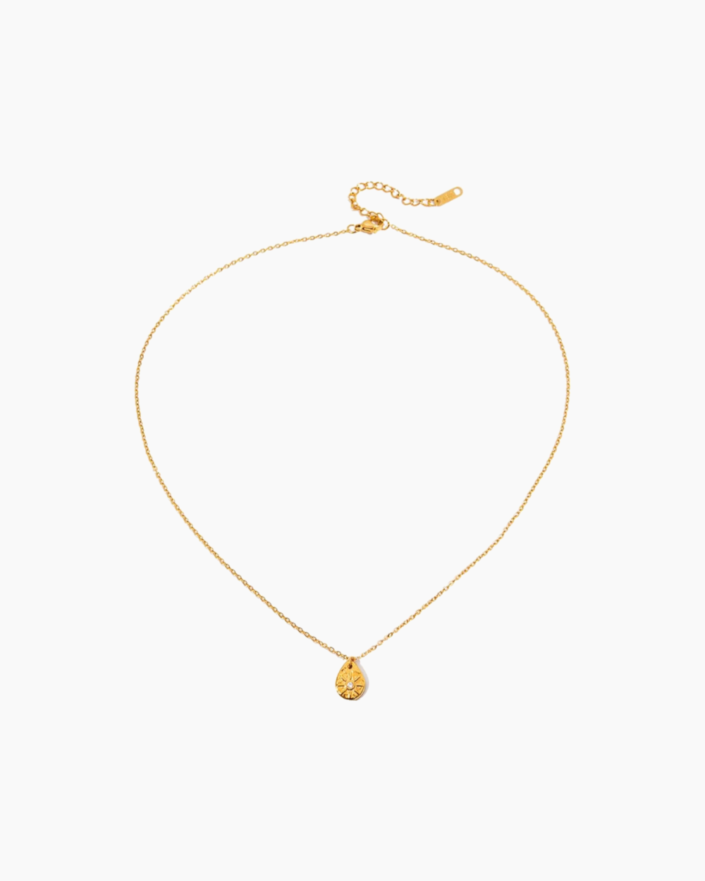 Gold necklace with a small pendant on a white background