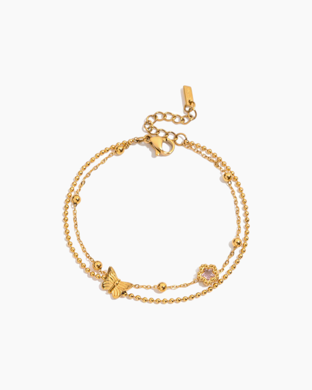Gold bracelet with butterfly and heart charms on a white background