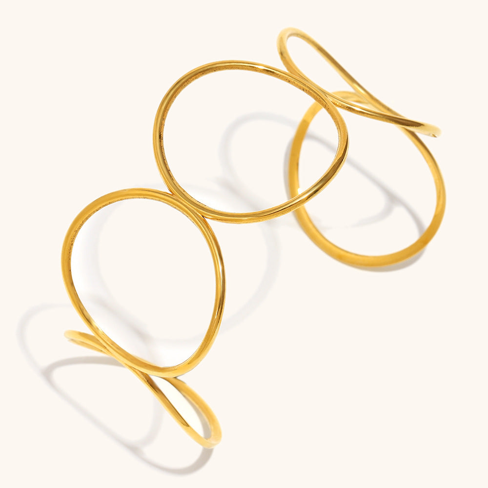 Minimalist hollow cuff bracelet in shiny gold, photographed from front view on neutral background.