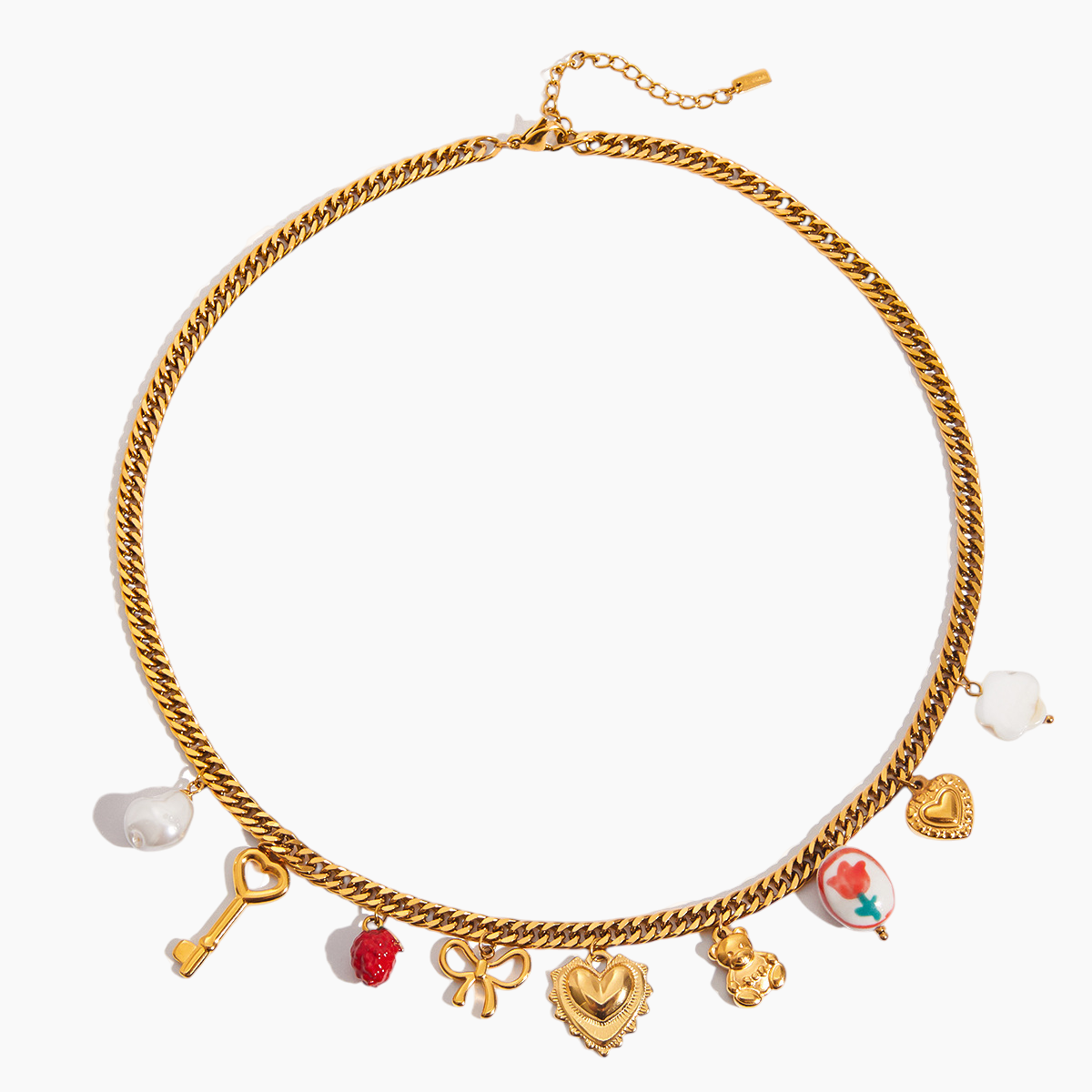 Gold chain necklace with various charms on a white background