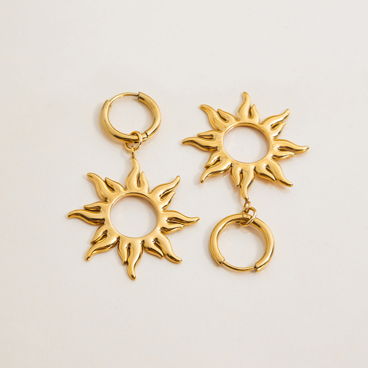 Stylish gold sunburst earrings displayed for product detail
