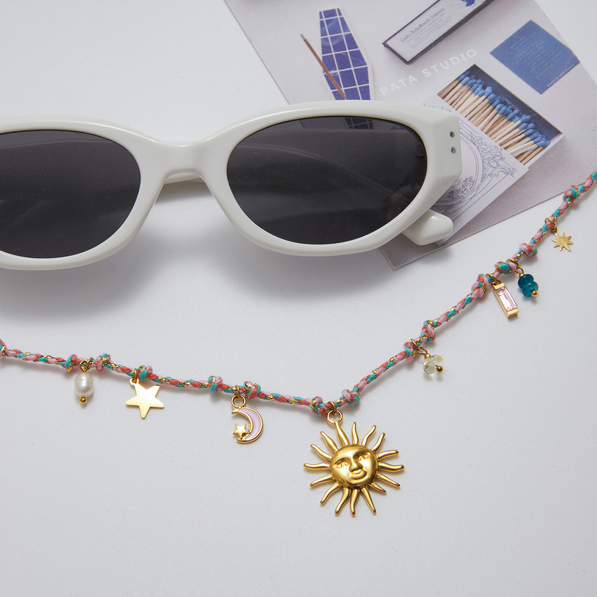 Handmade summer necklace with gold sun, moon, and pearl accents