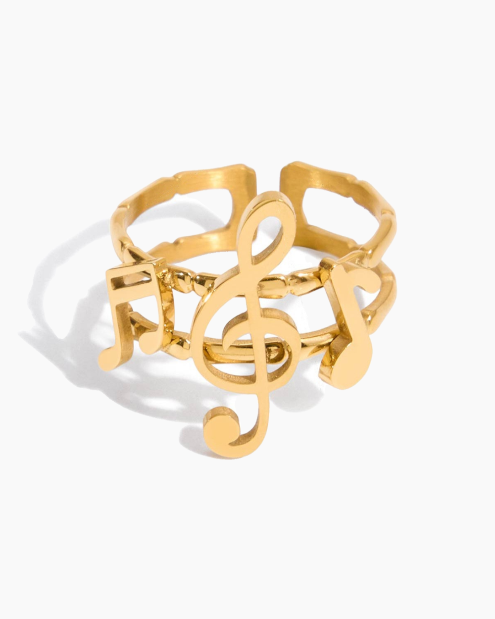 Gold ring with musical note design on a white background