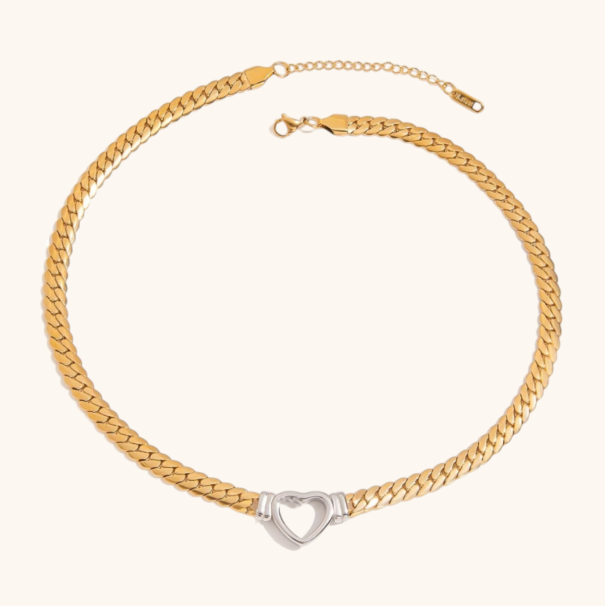 gold and silver heart pendant necklace on flat chain