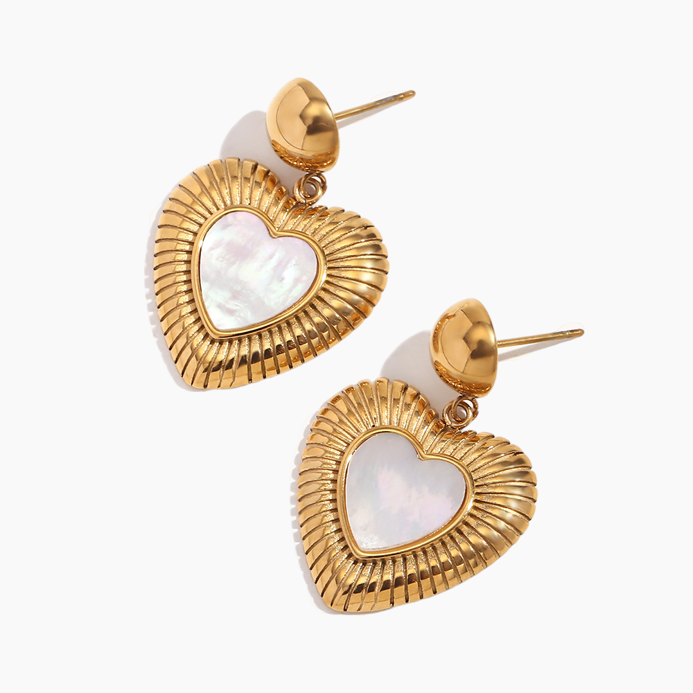 Gold heart-shaped earrings with a white center on a white background