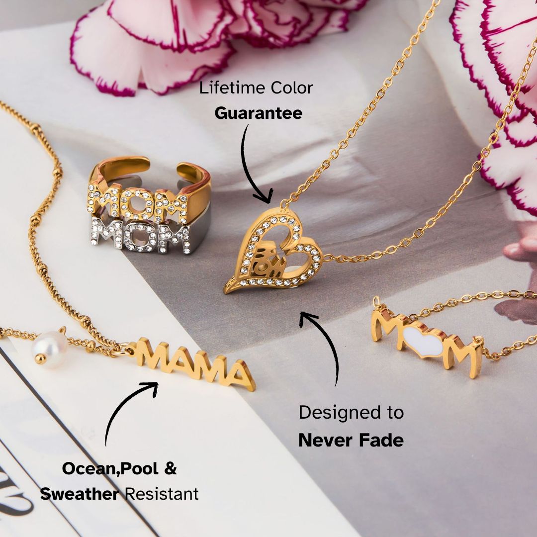 Set of MOM-themed gold jewelry with pearl and heart details, styled with flowers