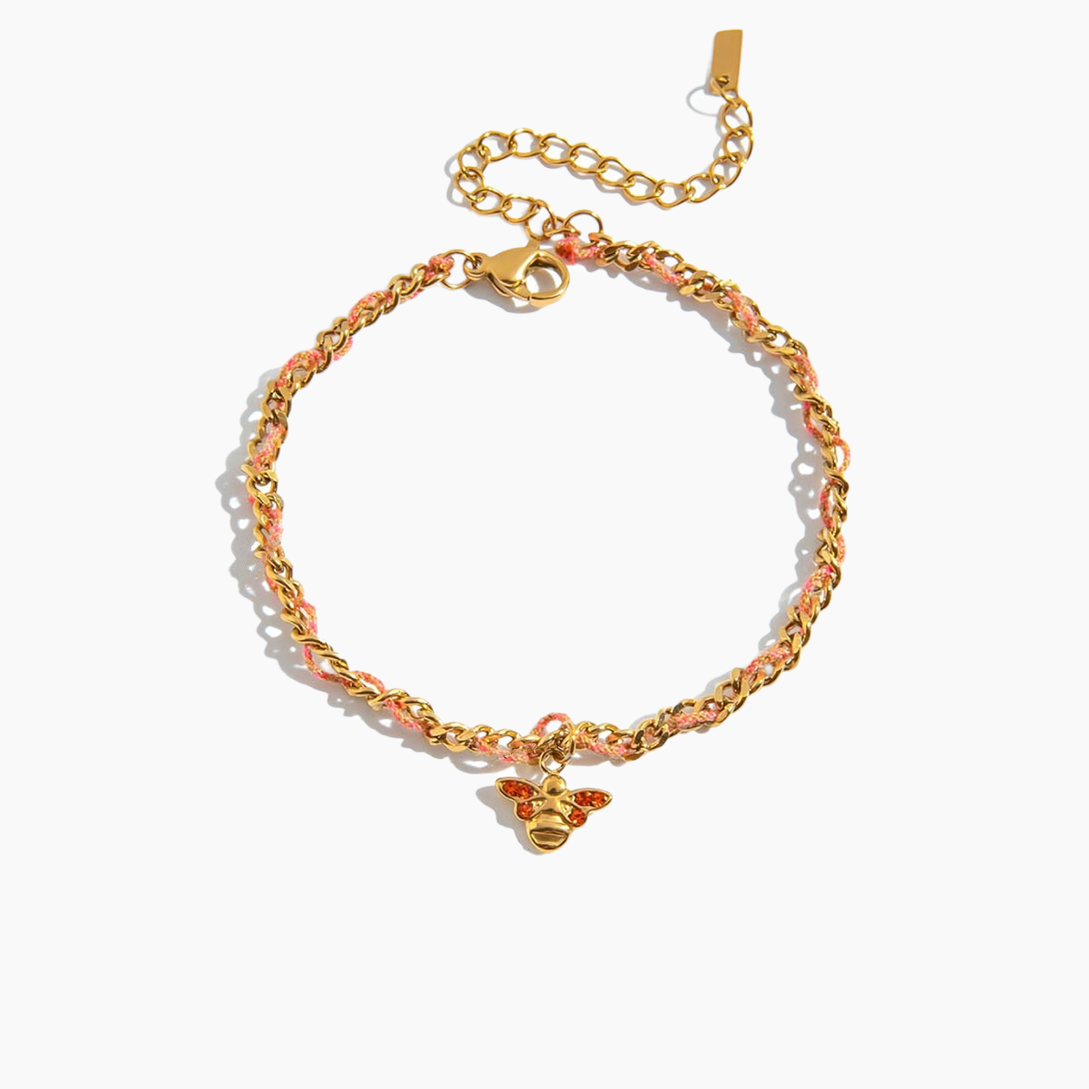 Gold chain bracelet with a bee charm on a white background