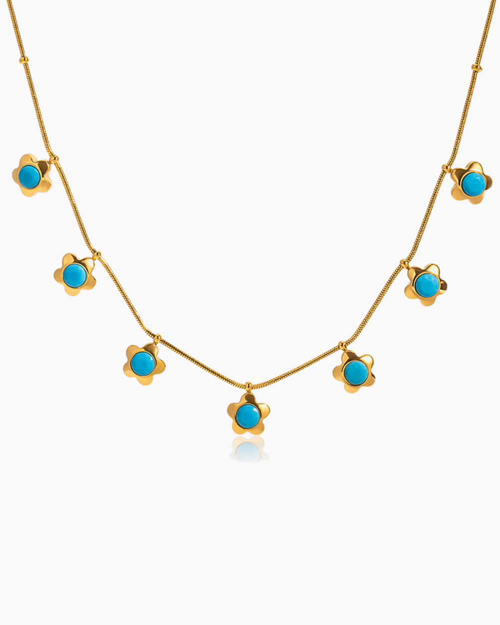Gold necklace with turquoise stones on a white background