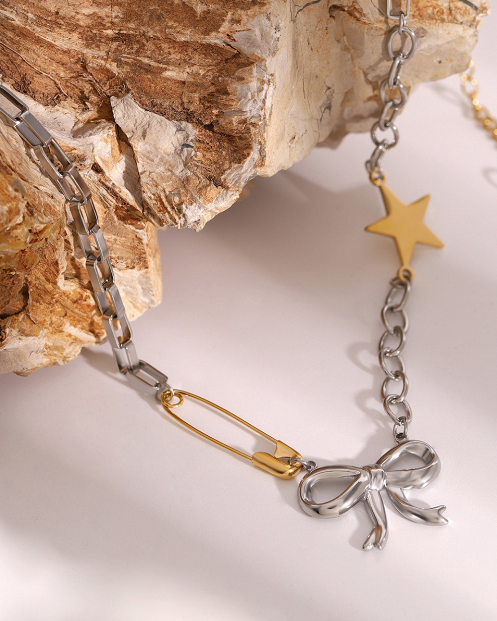 Bracelet with bow and star charms on a textured surface