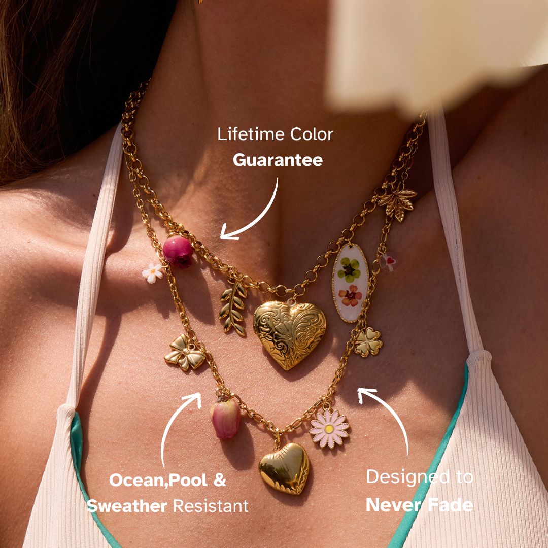 Layered necklaces with floral and heart charms on model in bikini