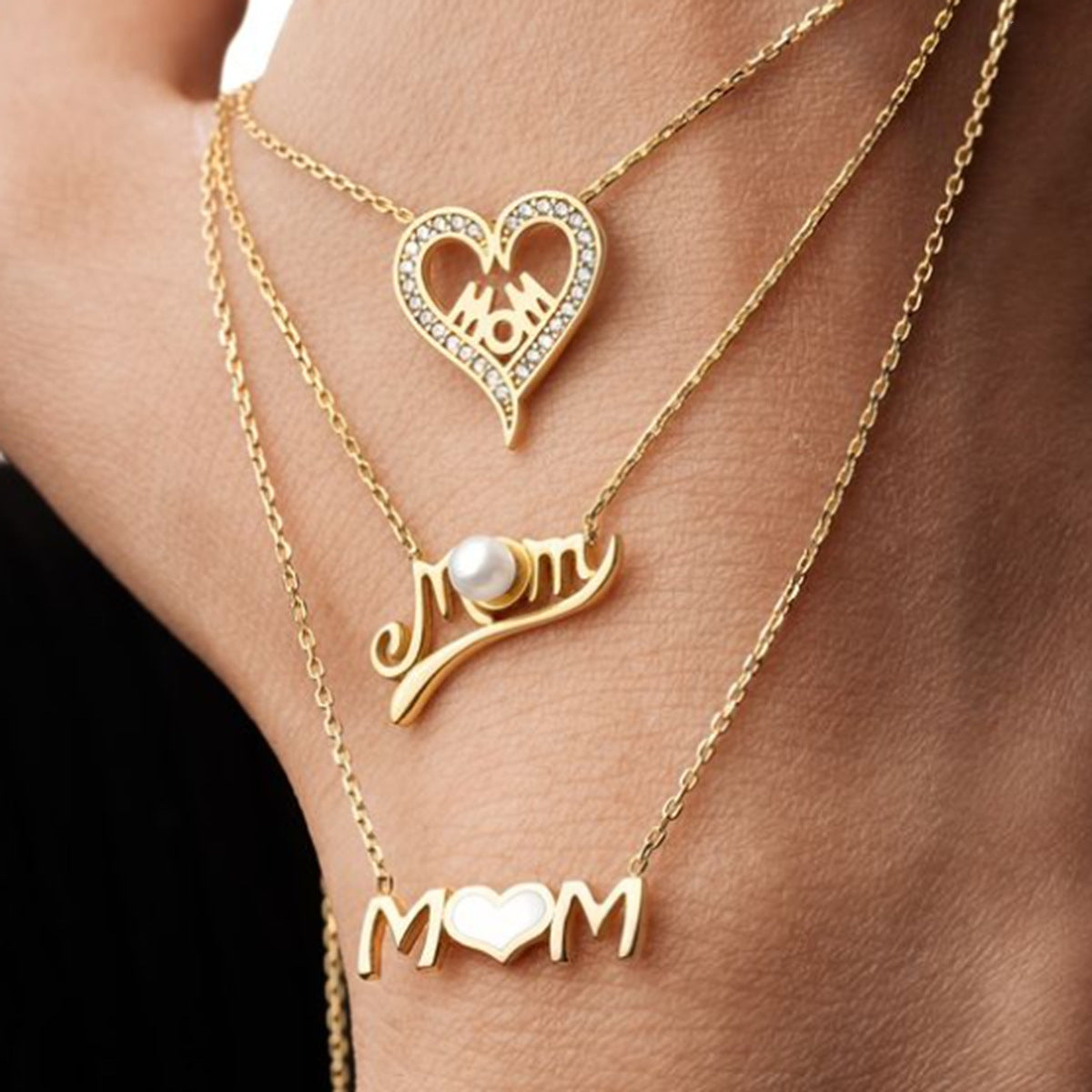 Stylish layered necklace set featuring heart MOM pendant on a woman's neckline
