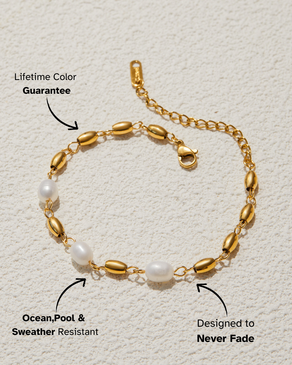 Gold bracelet with pearls on a textured beige background