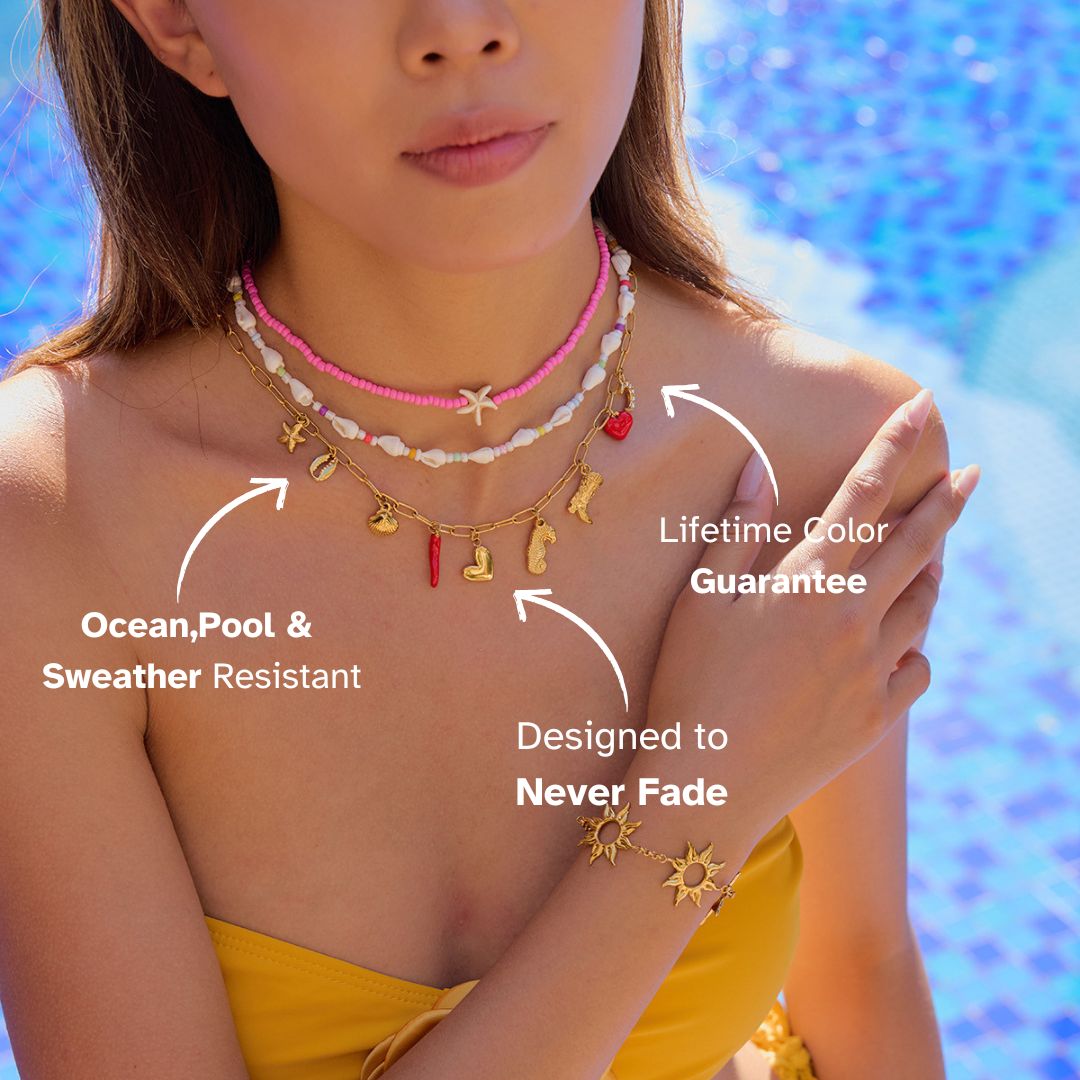 Model wearing layered pink, shell, and charm necklaces by the pool, styled with a yellow bikini top.