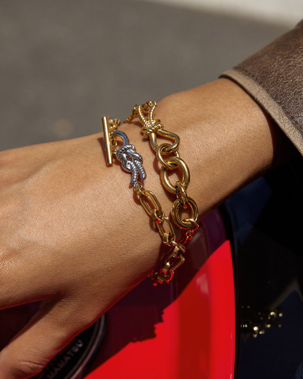 Gold chain bracelet on a wrist with a blurred background