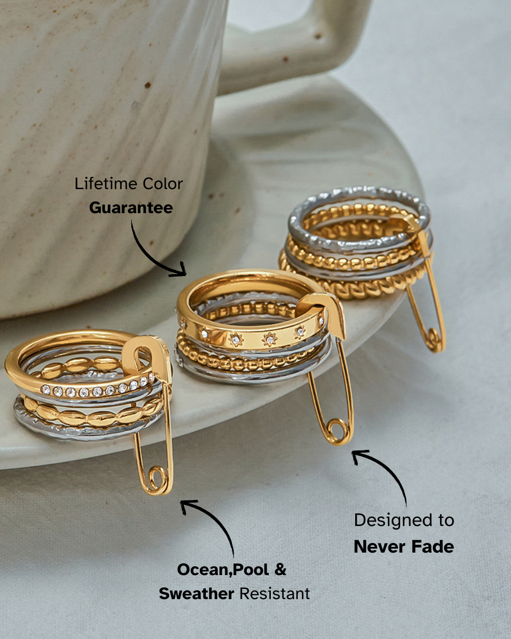 Gold and silver rings on a ceramic saucer with text about color guarantee and resistance.