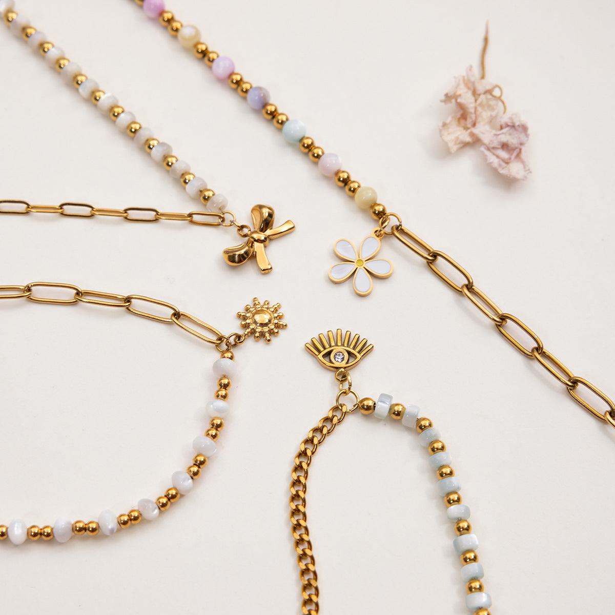 Gold and beaded bracelets on a light background