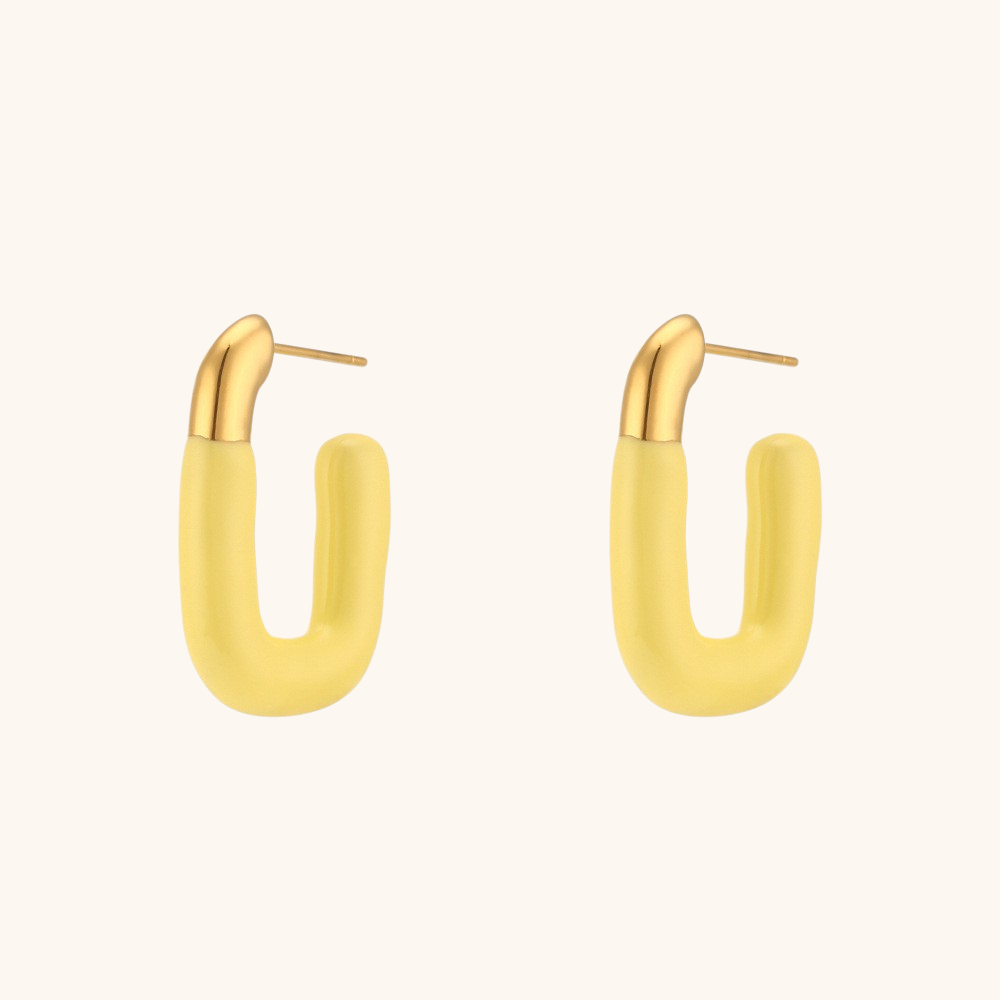 Single yellow enamel U-shaped earring with glossy gold accent on model’s ear