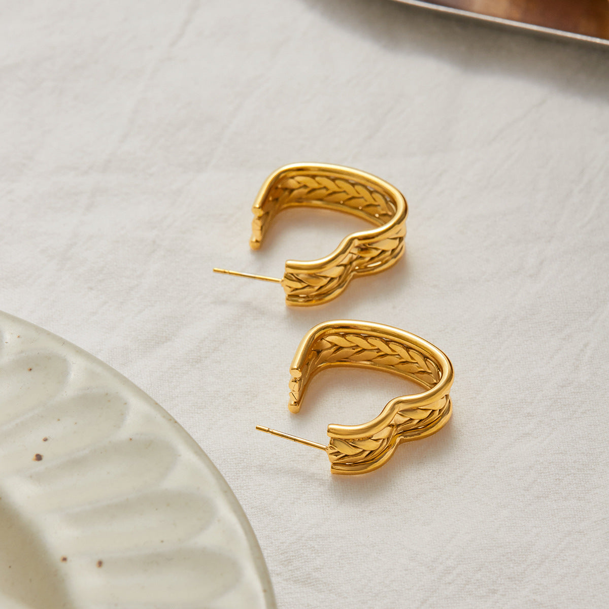 Statement gold hoops paired with soft glam makeup