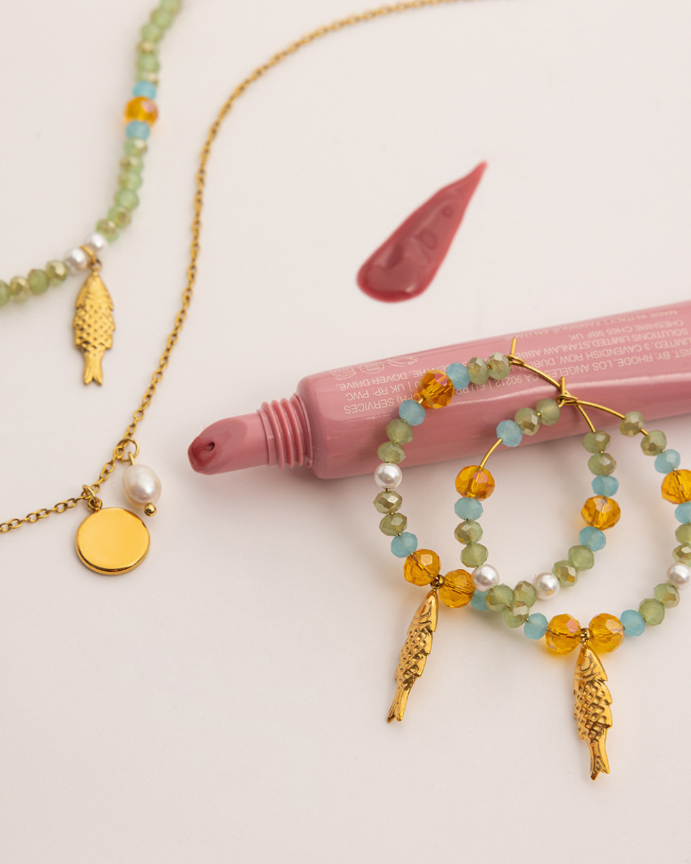Jewelry set with beaded necklaces and earrings on a light background