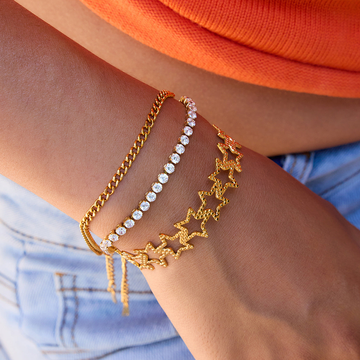 Gold star bangle styled with tennis bracelet and chain