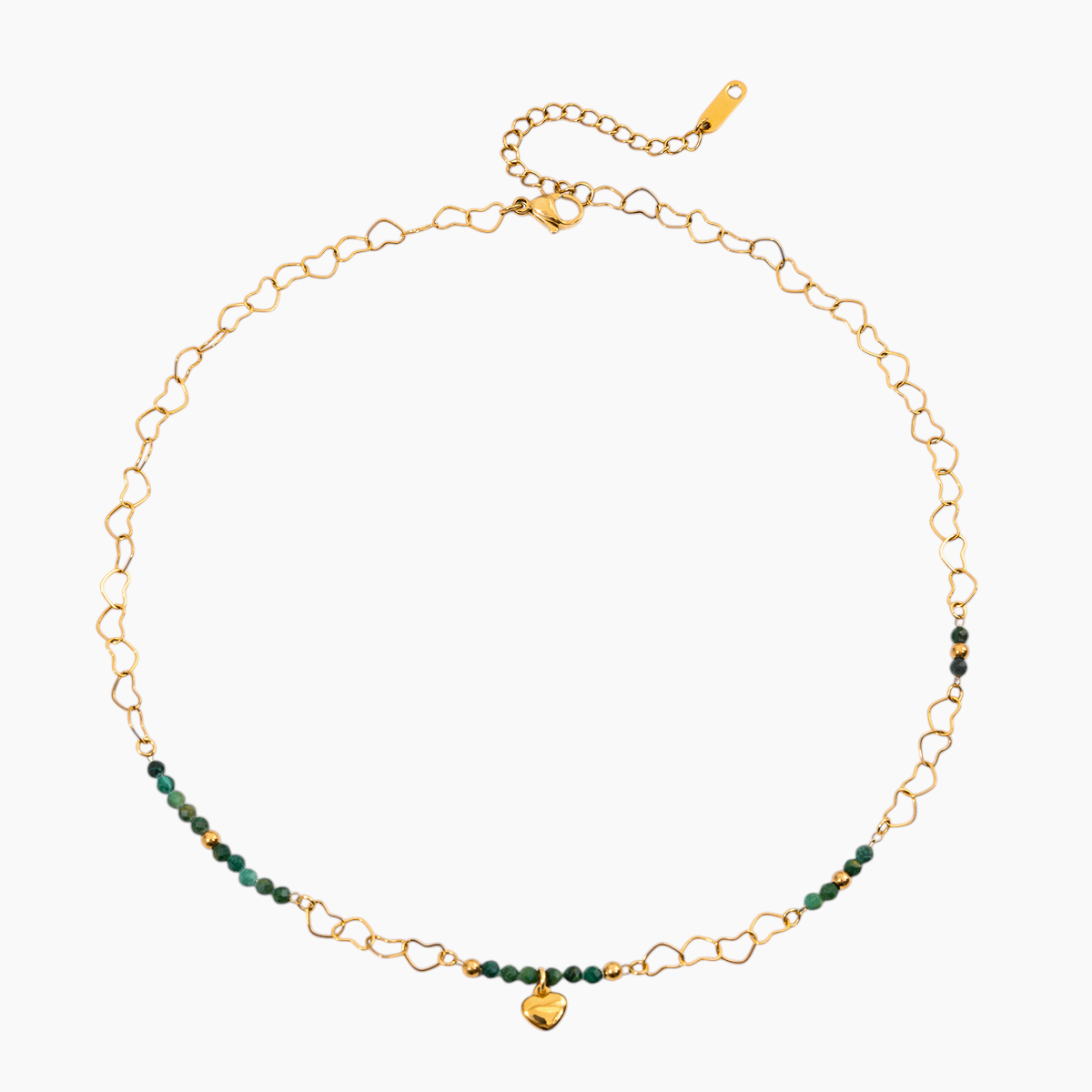 Gold chain necklace with green beads on a white background