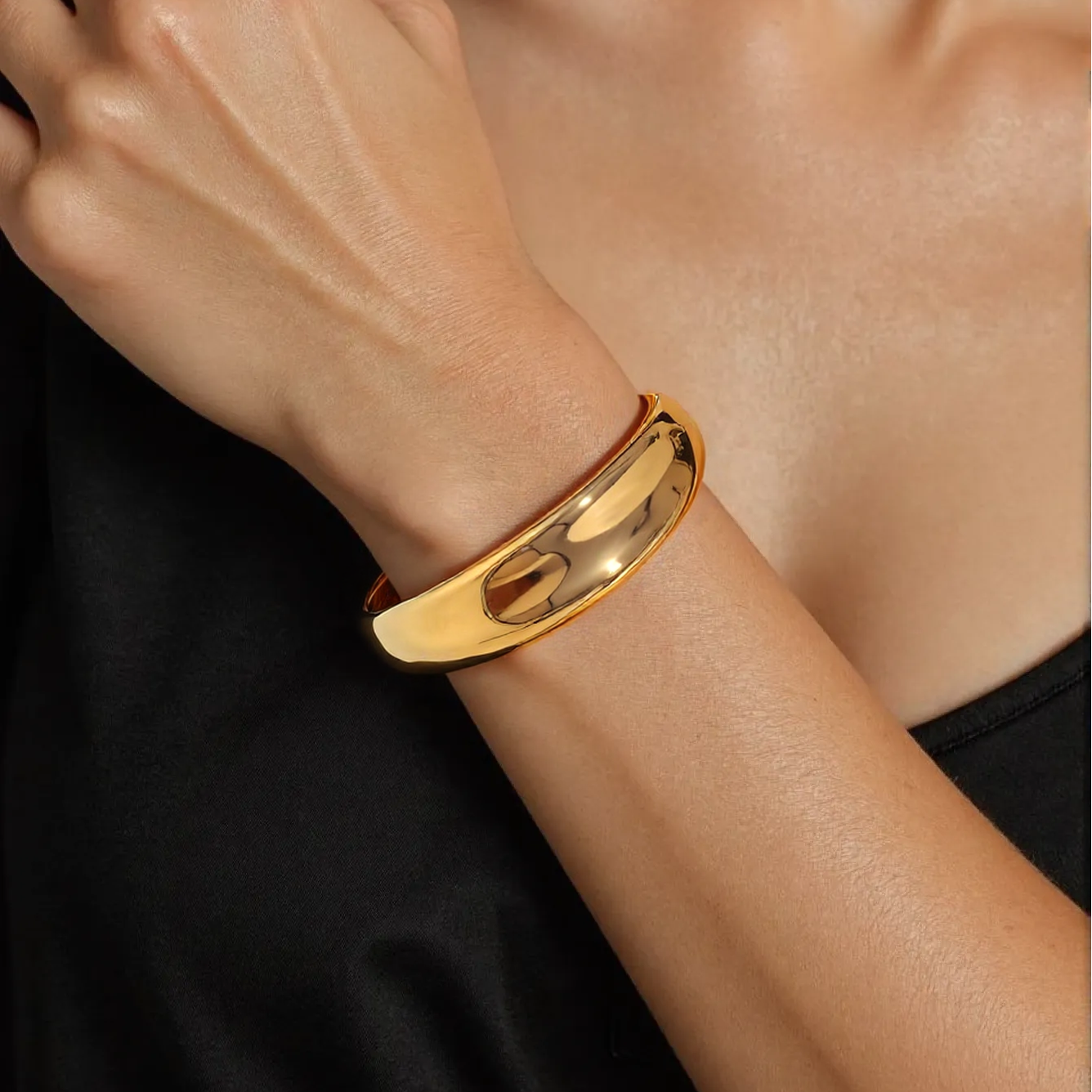 Model wearing sleek dome cuff over rolled sleeve for office elegance