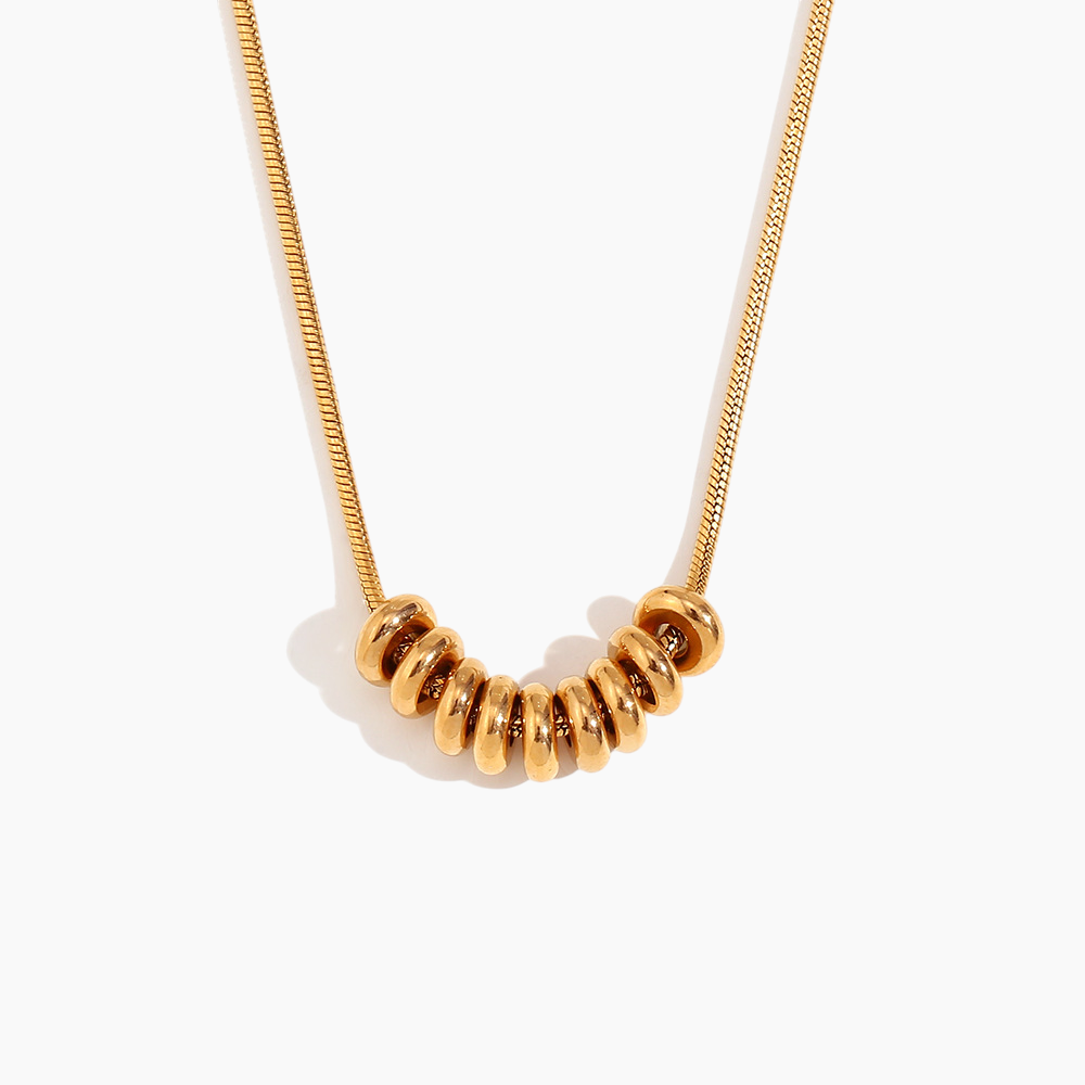 Gold necklace with beaded pendant on a white background