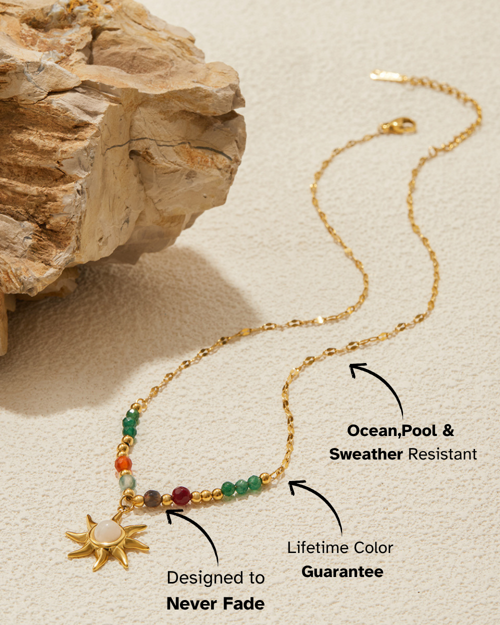 Gold necklace with colored beads and sun charm on a textured beige surface
