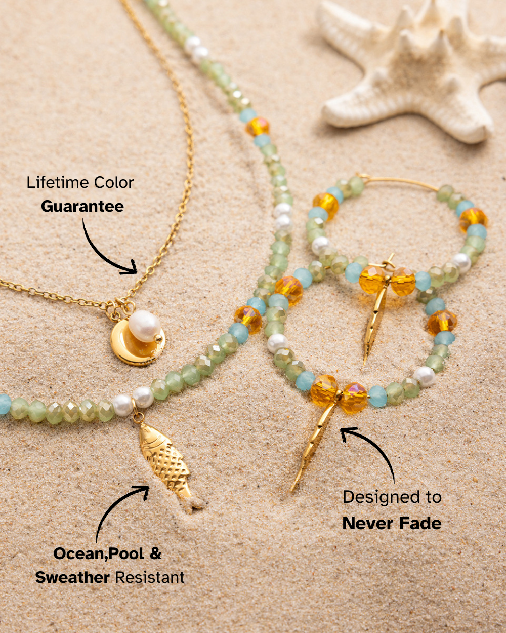 Jewelry set including necklace, bracelet, and earrings on sand with starfish