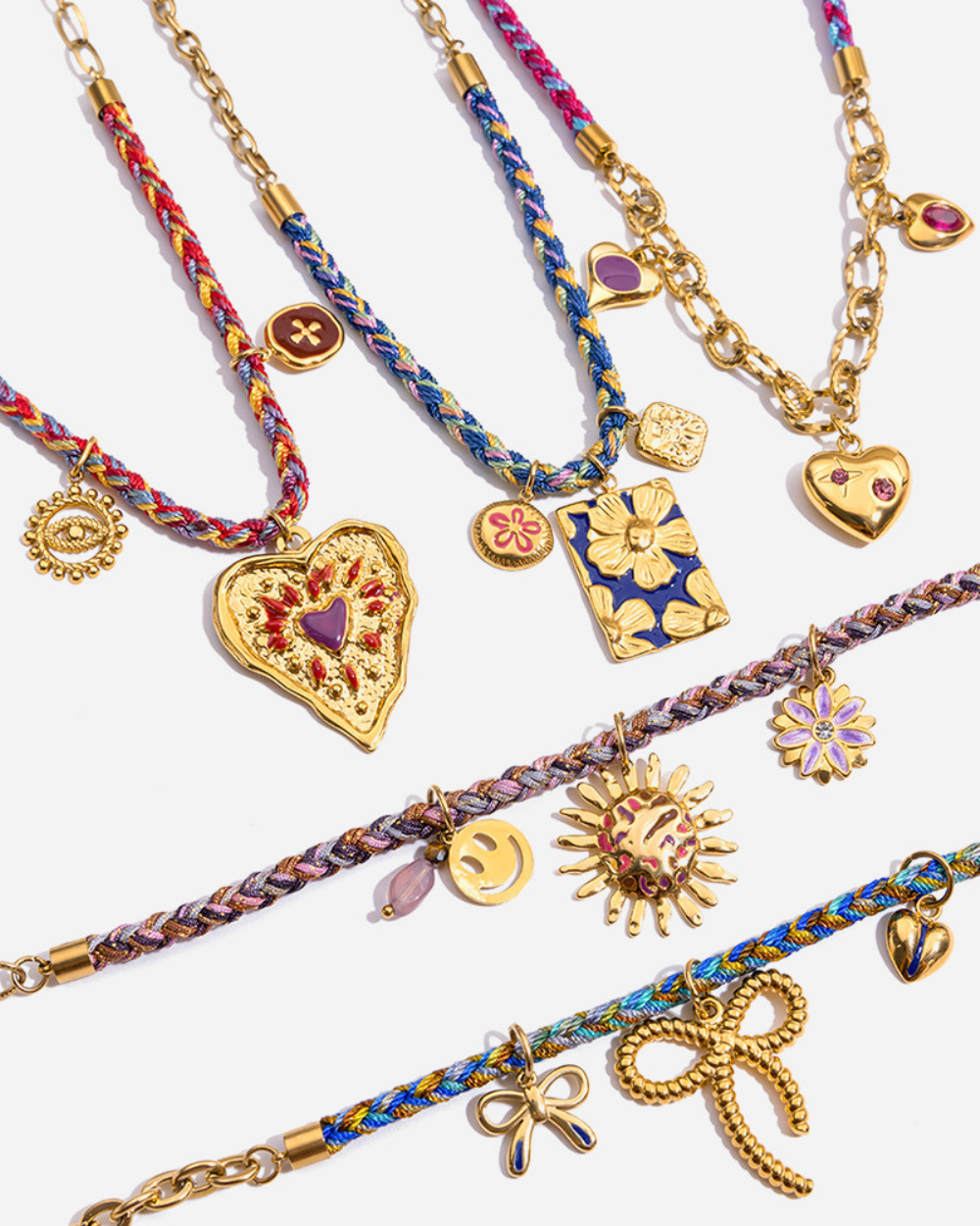 Collection of colorful braided bracelets with various charms on a white background