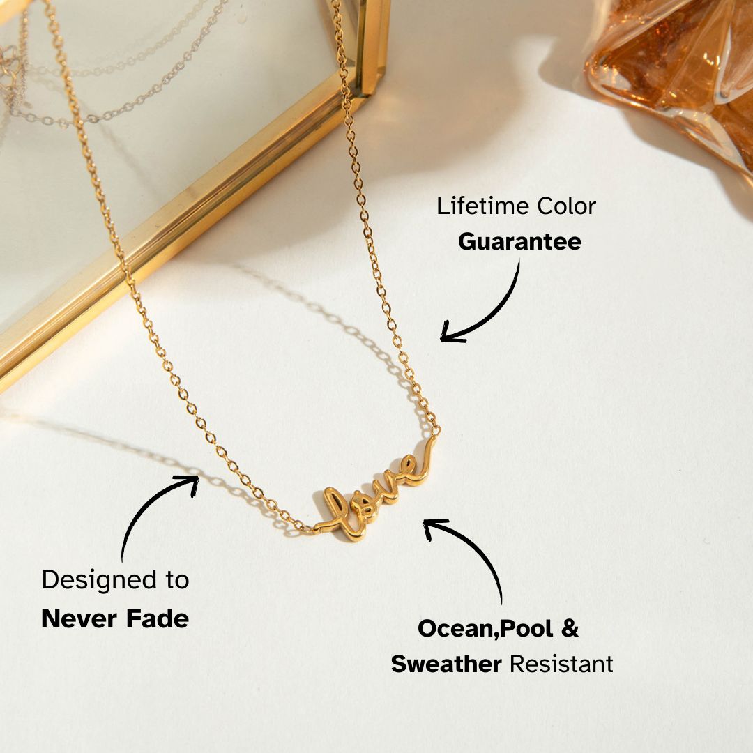 Close-up of gold minimalist "love" necklace with elegant script design