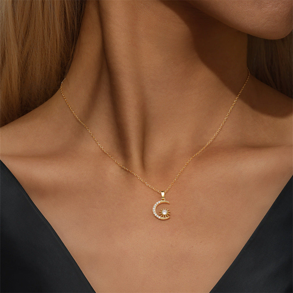 Delicate gold crescent moon necklace styled with black top, perfect for everyday layering.