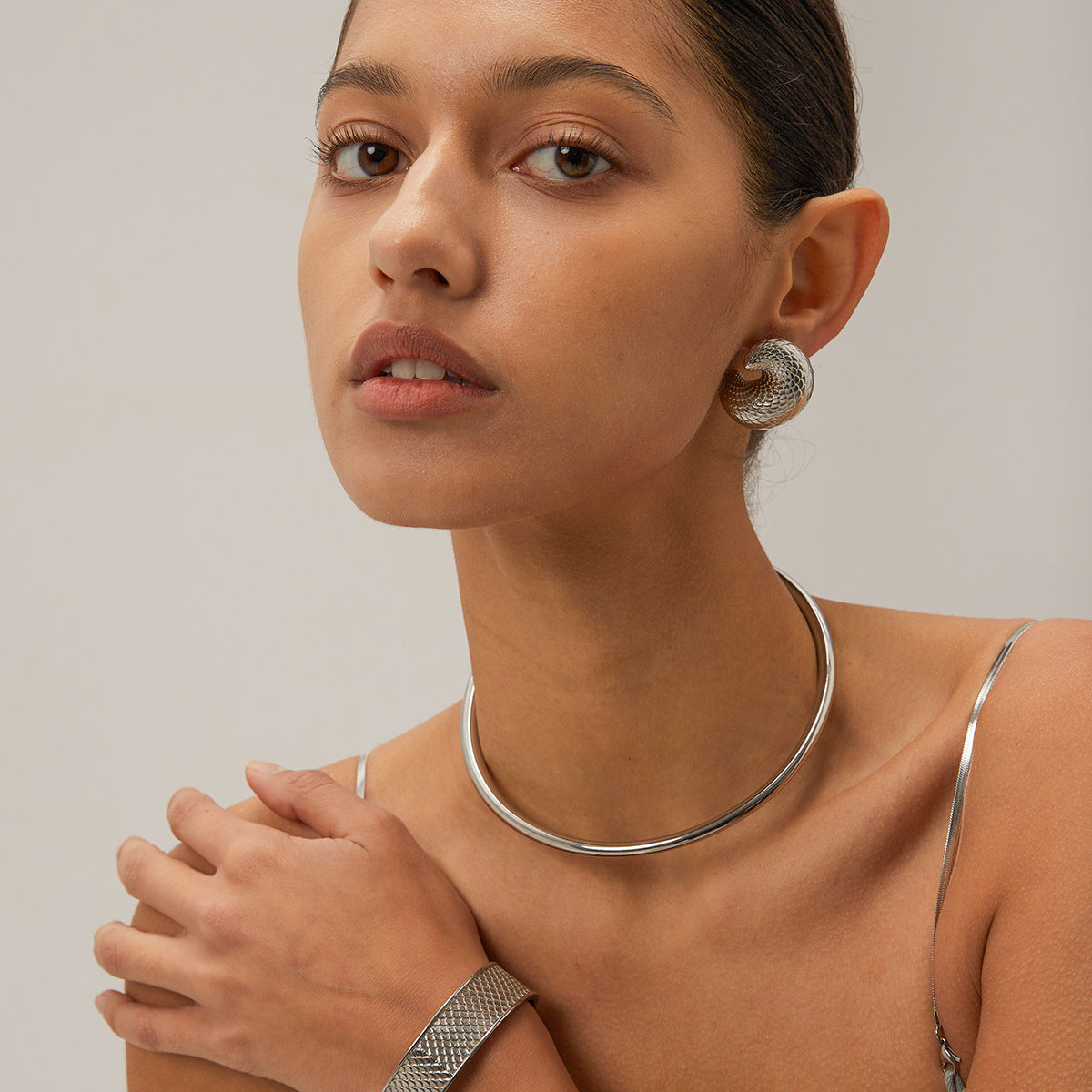Simple silver choker necklace on model, clean and elegant design