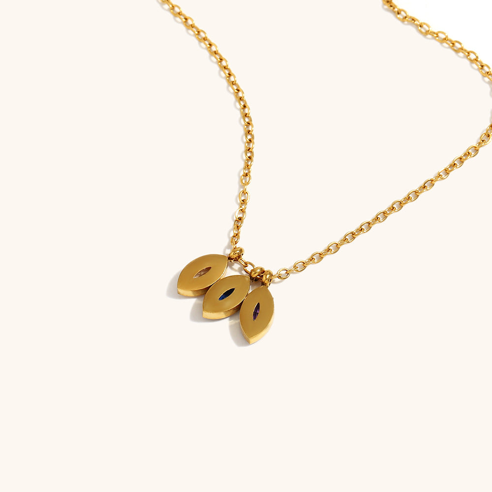 Back view of gold necklace showing smooth finish and gemstone backs