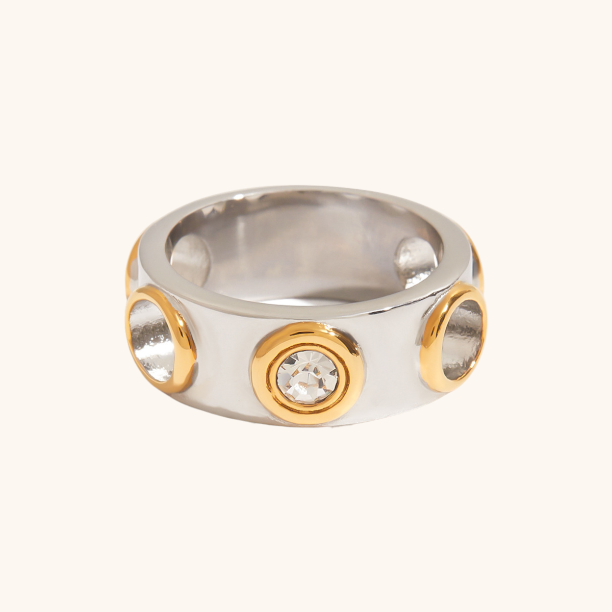 Chunky two-tone ring with gold-framed CZ stones on a silver band