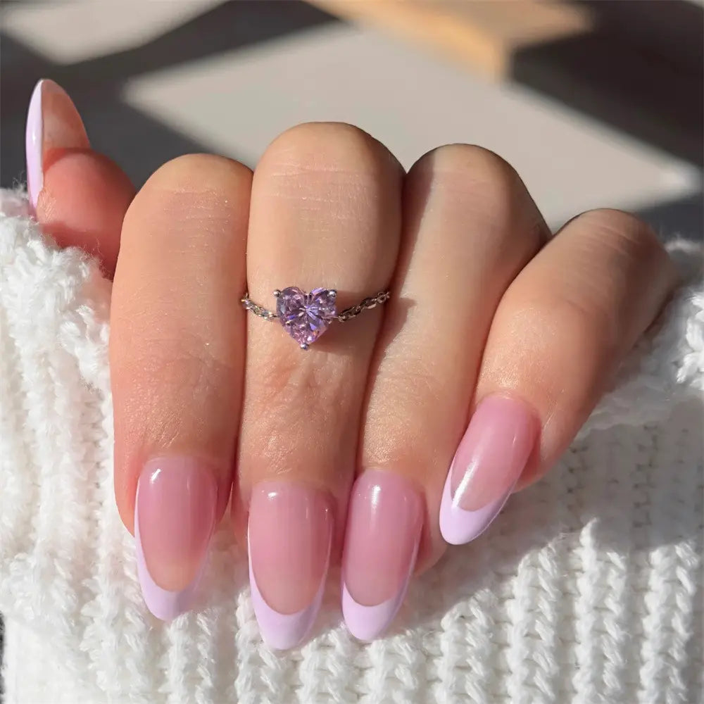 Close-up of a model wearing a 925 sterling silver heart-shaped purple zirconia ring on their finger.