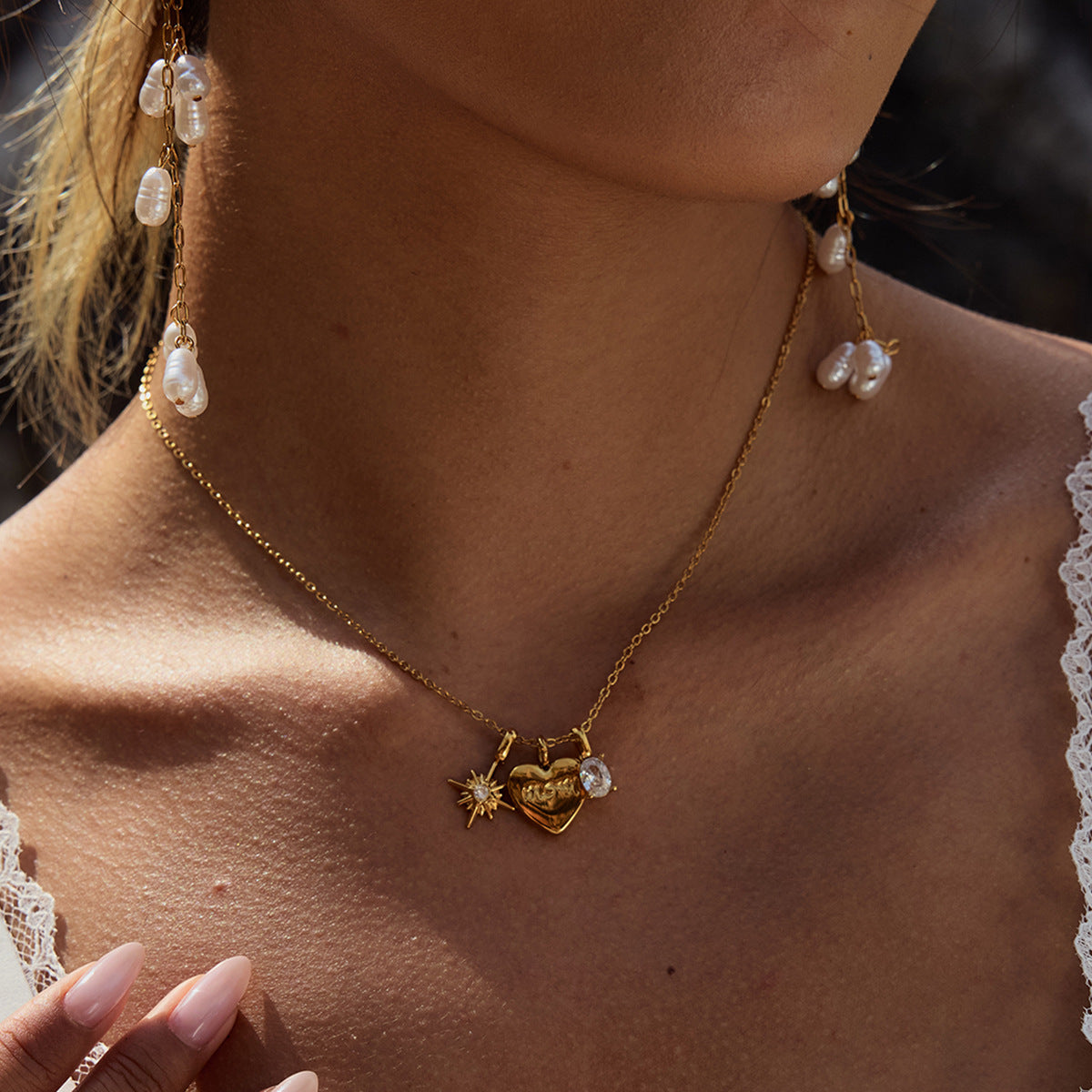 Woman wearing gold mom pendant necklace outdoors in natural light