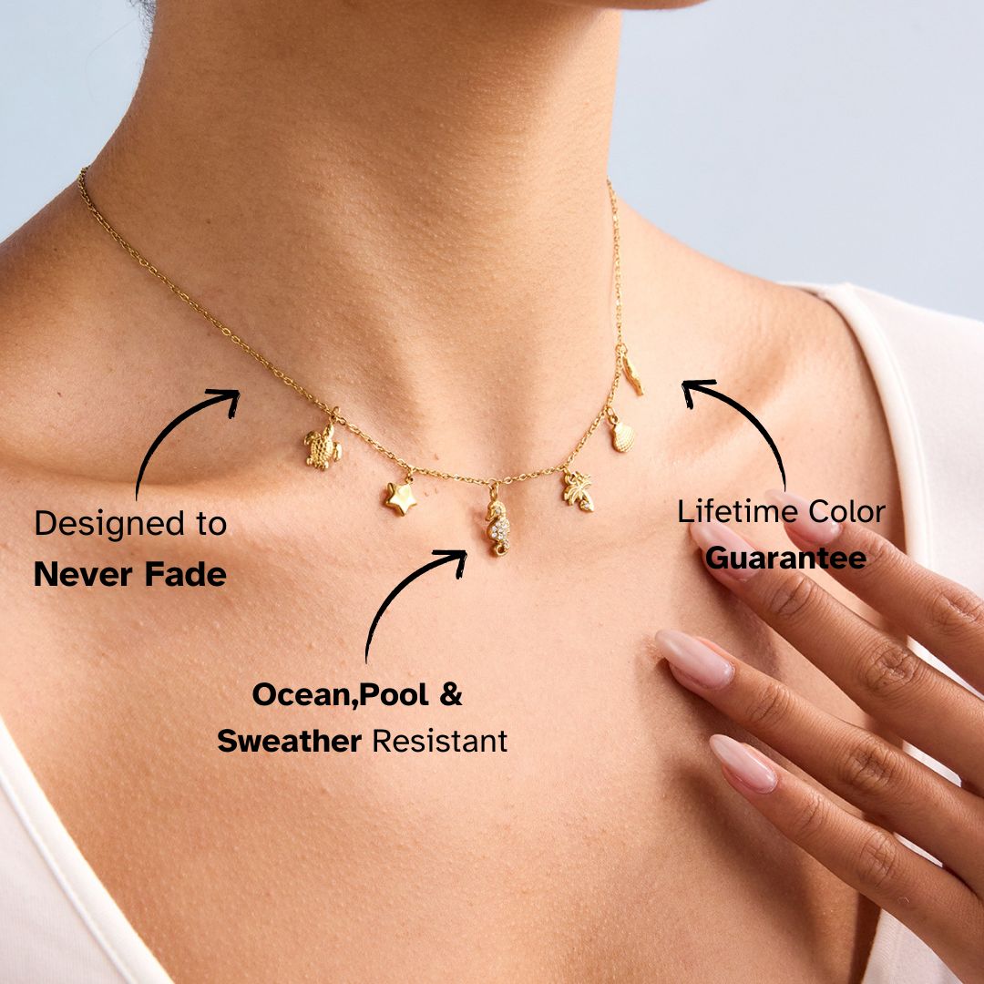 Model neck detail with seahorse, palm tree and ocean charms gold necklace